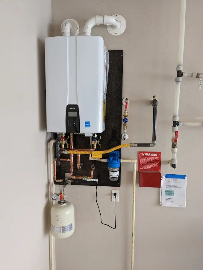 Professional plumber installing copper piping in a Easton home